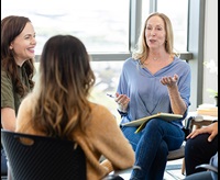 female therapist speaking in a group session