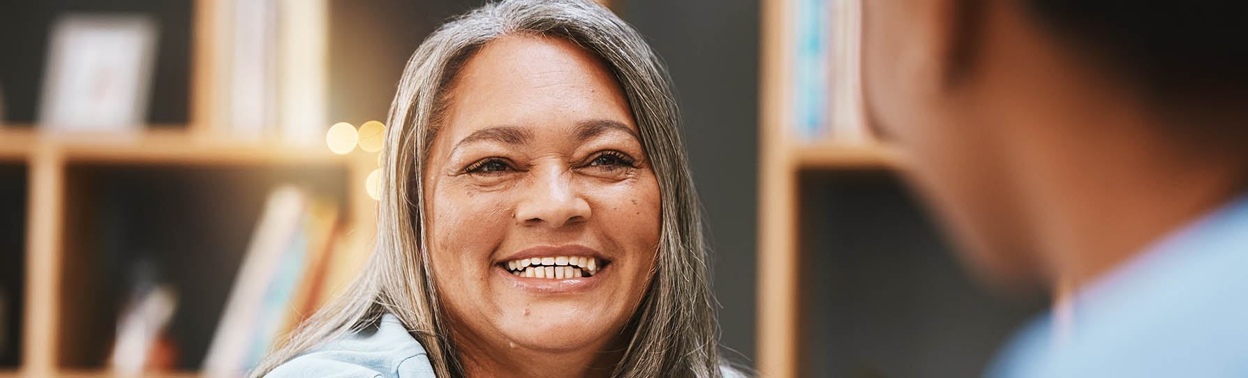 Woman with a smile talking to a doctor