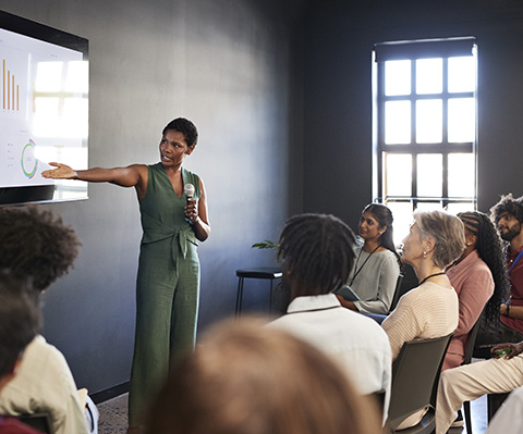 A teaching giving a class to a group of people